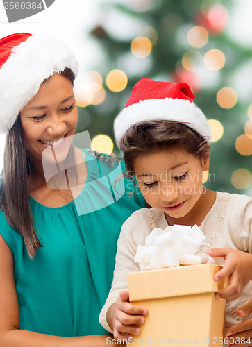 Image of happy mother and child girl with gift box