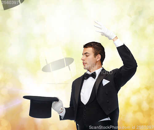 Image of magician in top hat showing trick