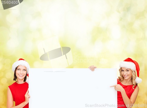 Image of women in santa helper hats with blank white board