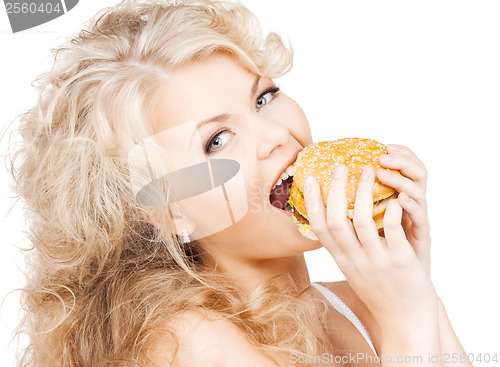 Image of beautiful happy woman with burger