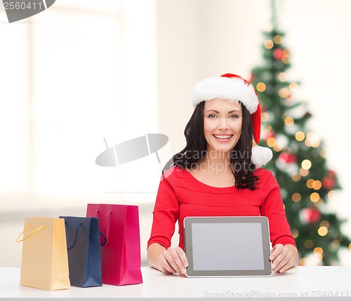 Image of smiling woman in santa helper hat with tablet pc