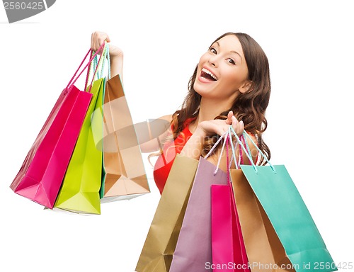Image of woman in red dress with colorful shopping bags