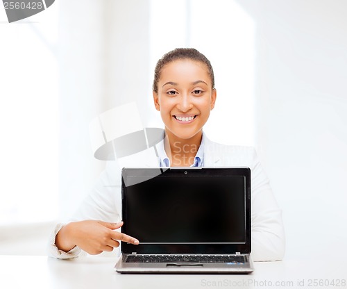 Image of smiling woman with laptop computer