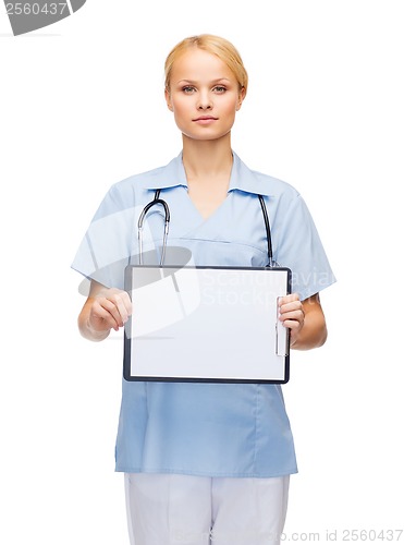 Image of smiling female doctor or nurse with sclipboard