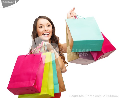 Image of woman in red dress with colorful shopping bags