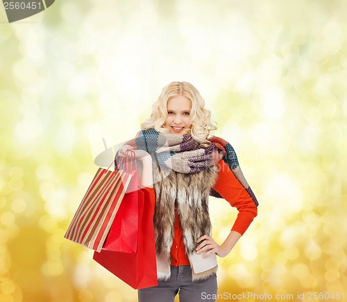 Image of teenage girl in winter clothes with shopping bags