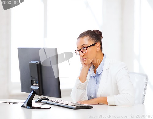 Image of african businesswoman with computer in office