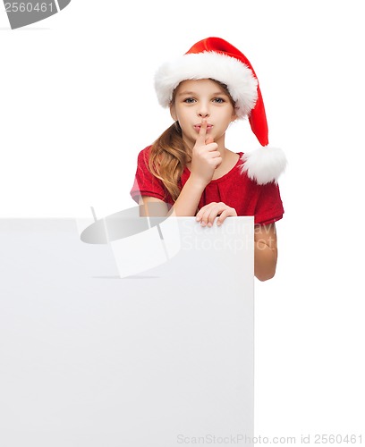 Image of child in santa helper hat with blank white board