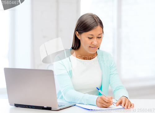 Image of asian businesswoman with laptop and documents