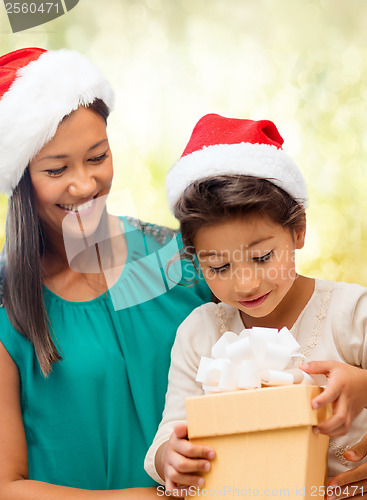 Image of happy mother and child girl with gift box