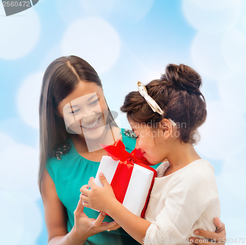 Image of happy mother and child girl with gift box