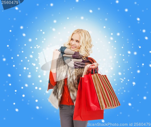 Image of teenage girl in winter clothes with shopping bags