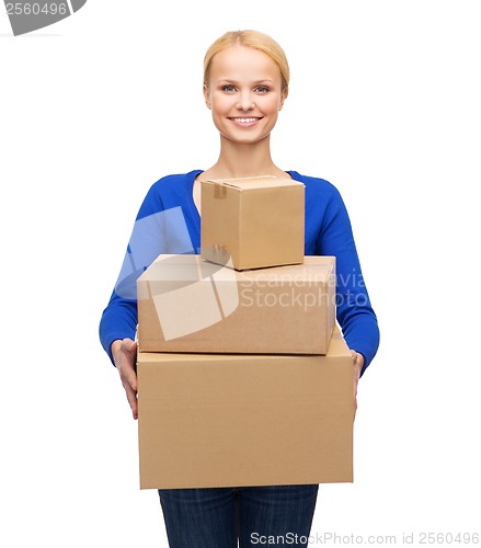 Image of smiling woman in casual clothes with parcel boxes