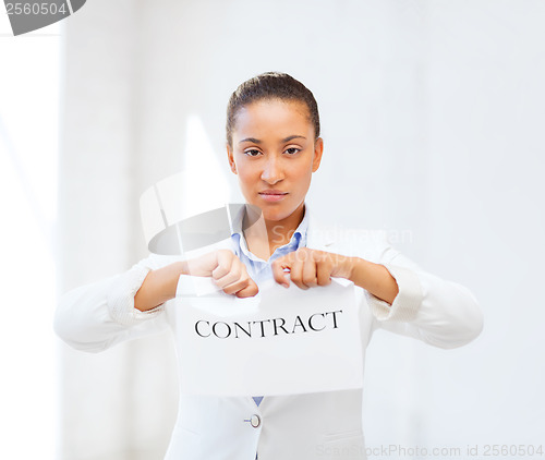 Image of african businesswoman tearing contract