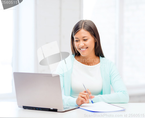 Image of asian businesswoman with laptop and documents