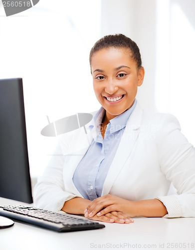 Image of african businesswoman with computer in office
