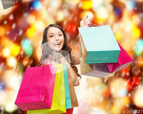 Image of woman in red dress with colorful shopping bags