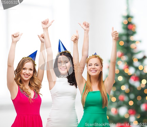 Image of three women wearing hats and showing thumbs up