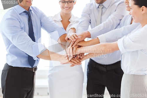 Image of business team celebrating victory in office