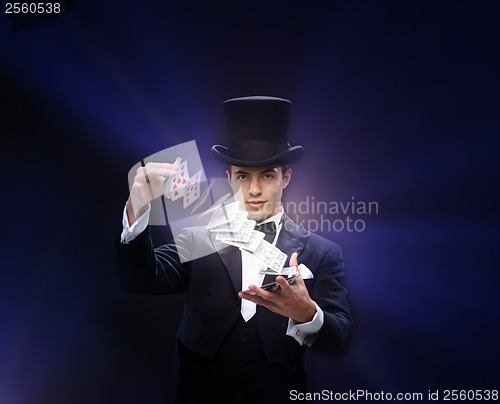 Image of magician showing trick with playing cards