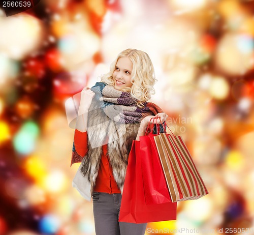 Image of teenage girl in winter clothes with shopping bags