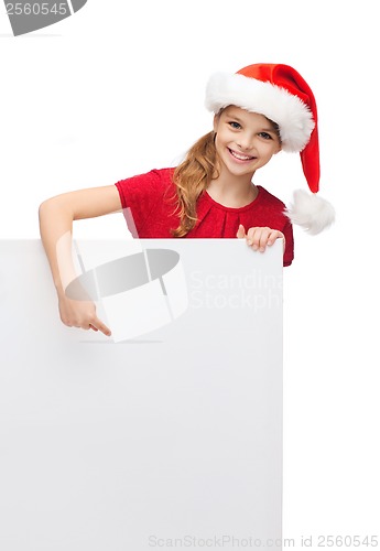 Image of child in santa helper hat with blank white board