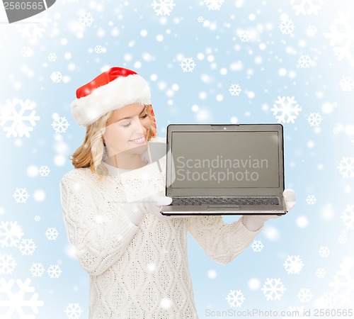 Image of woman in santa helper hat with laptop computer