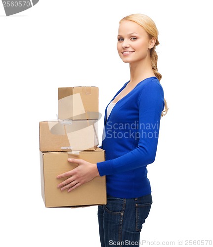 Image of smiling woman in casual clothes with parcel boxes