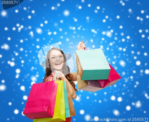 Image of woman in red dress with colorful shopping bags