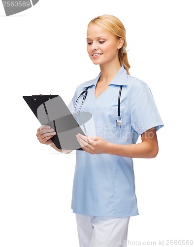 Image of smiling female doctor or nurse with clipboard