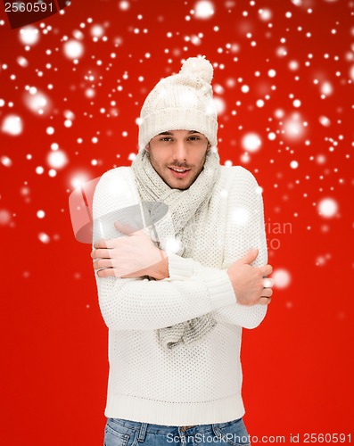 Image of man in warm sweater, hat and scarf