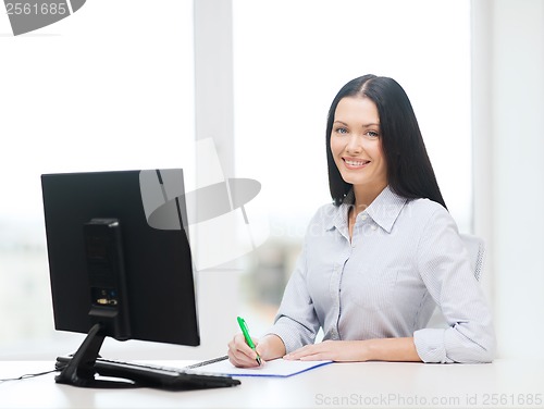 Image of smiling businesswoman or student studying