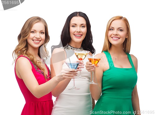 Image of three smiling women with cocktails