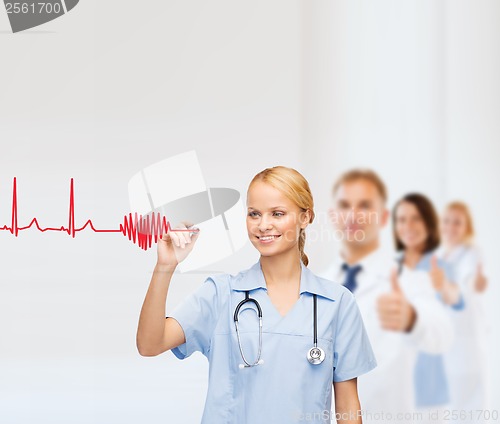 Image of smiling doctor or nurse drawing electrocardiogram