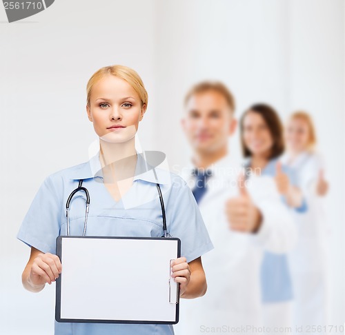 Image of smiling female doctor or nurse with sclipboard