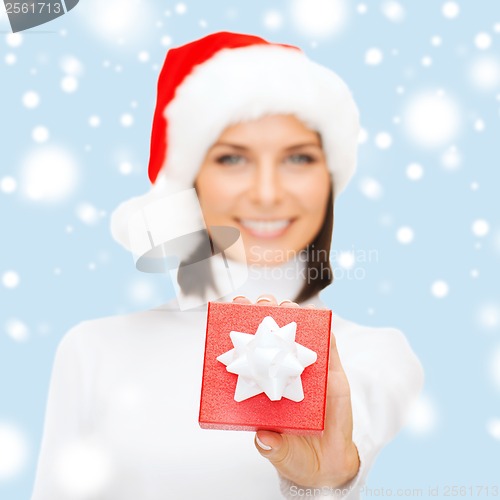Image of woman in santa helper hat with small gift box