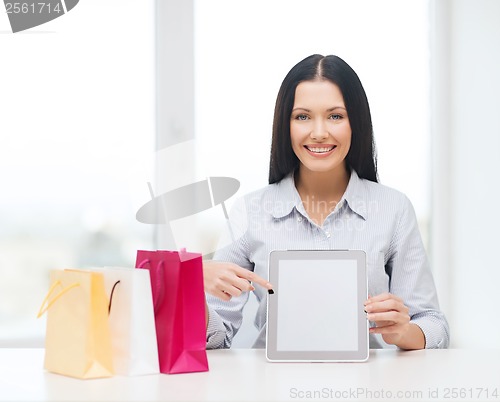 Image of smiling woman with blank screen tablet pc