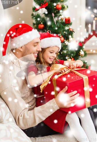 Image of smiling father and daughter opening gift box