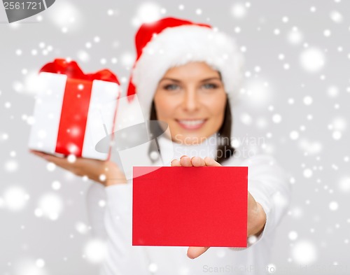 Image of smiling woman in santa helper hat with postcard