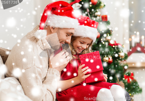 Image of smiling father and daughter opening gift box