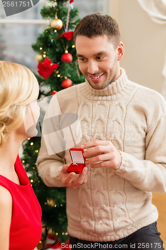 Image of romantic man proposing to a woman