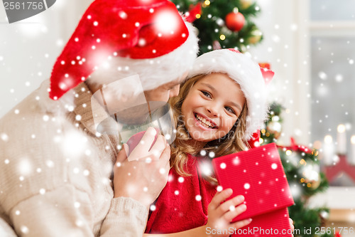 Image of smiling father and daughter opening gift box