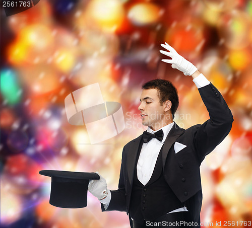 Image of magician in top hat showing trick