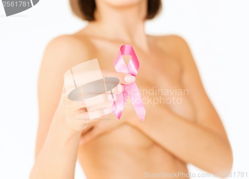 Image of hand holding pink breast cancer awareness ribbon