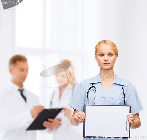 Image of smiling female doctor or nurse with sclipboard