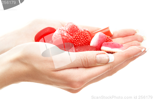 Image of hands full of red bonbons