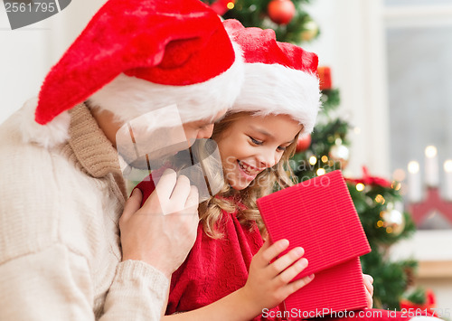 Image of smiling father and daughter opening gift box