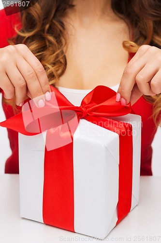 Image of woman hands opening gift boxes