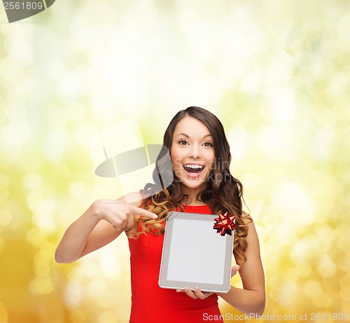 Image of smiling woman in red dress with tablet pc