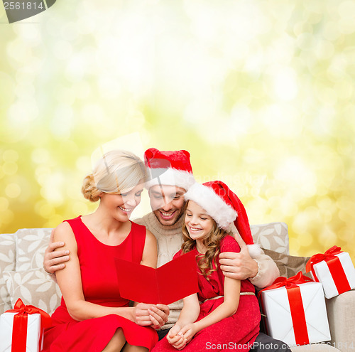 Image of smiling family reading postcard